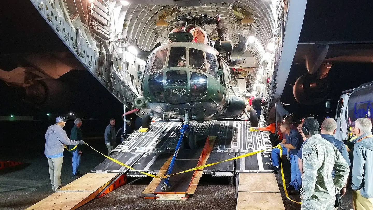 An Afghan Air Force Mi-17 helicopter is loaded into a cargo plane. The US government has considered transferring ex-Afghan Air Force Mi-17s to the Ukrainian military.