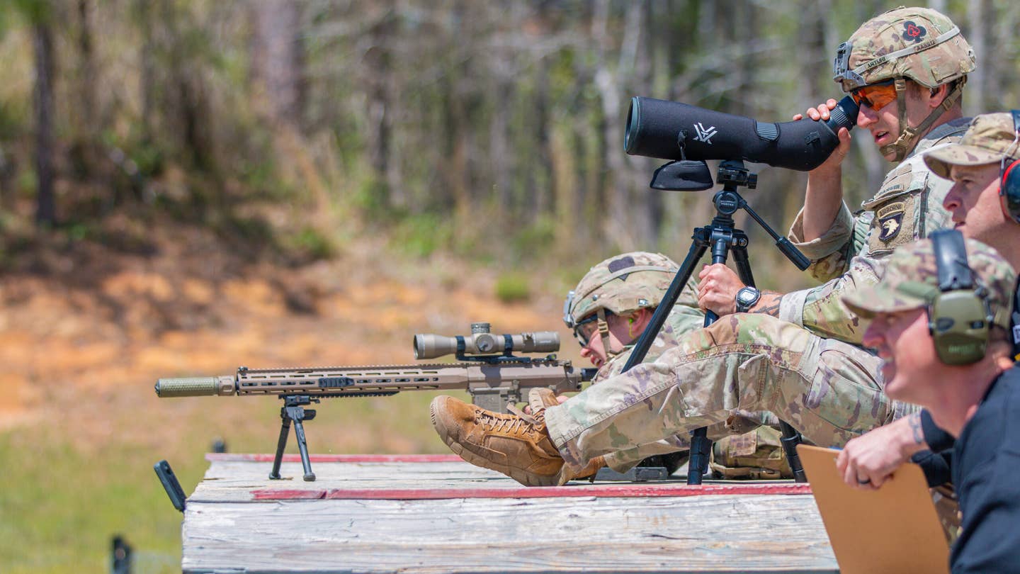 1st Lt. Aaron Arturi (front) and 1st Lt. John Ryan from the 101st Airborne Division (Air Assault), takes aim at stress shoot event at the Annual Best Ranger Competition in Fort Benning, Ga on April 9th, 2022. Ryan is aiming down range at the targets while Arturi is spotting him. The spotter helps the sniper stay on track so they can hit their target.