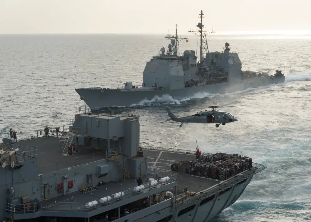 Guided-missile cruiser <em>USS Bunker Hill</em> (CG 52), right, comes alongside Military Sealift Command fast combat support ship <em>USNS Rainier</em> (T-AOE 7) during a replenishment at sea. The <em>Bunker Hill</em> is on the Navy's list to be retired in Fiscal Year 2023. (U.S. Navy photo by Mass Communication Specialist 3rd Class James Vazquez/Released).