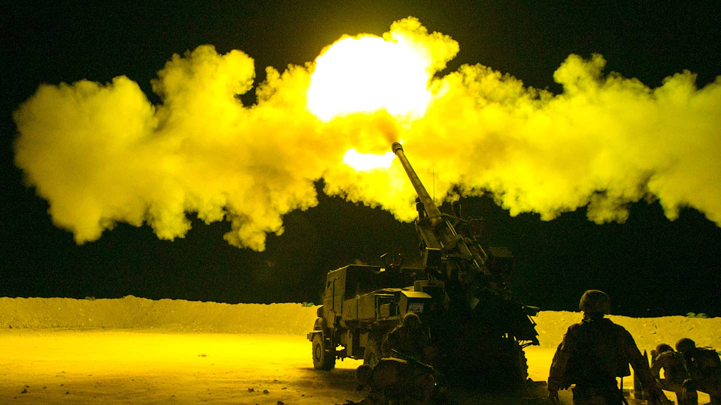 French soldiers, assigned to Task Force Wagram, conduct a fire mission in support of Operation Roundup, during the night in Al Qaim, Iraq May 16, 2018.