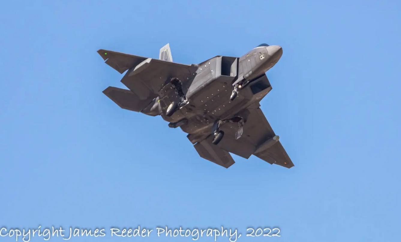 F-22 with never seen before stealthy under-wing pods. See the one on the right has an aperture area that would make sense for an IRST. (Credit: James Reeder Photography)