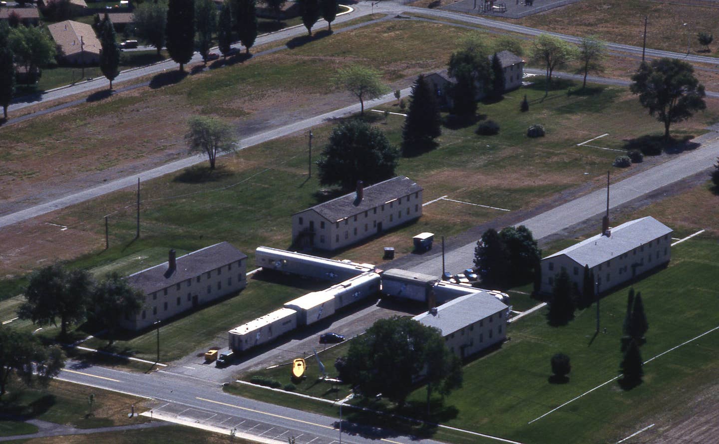 The Heritage Museum and Strategic Air Command B-52 Stratofortress and KC-135 Stratotanker simulator cars are seen while looking southeast at Fairchild Air Force Base, Washington, in 2002. Today, the museum buildings are gone. <em>US Air Force</em>