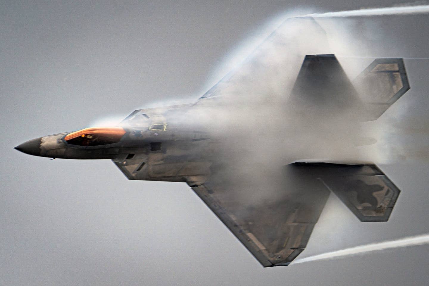 F-22 pulling vapor during a high-speed flyby. Credit: USAF