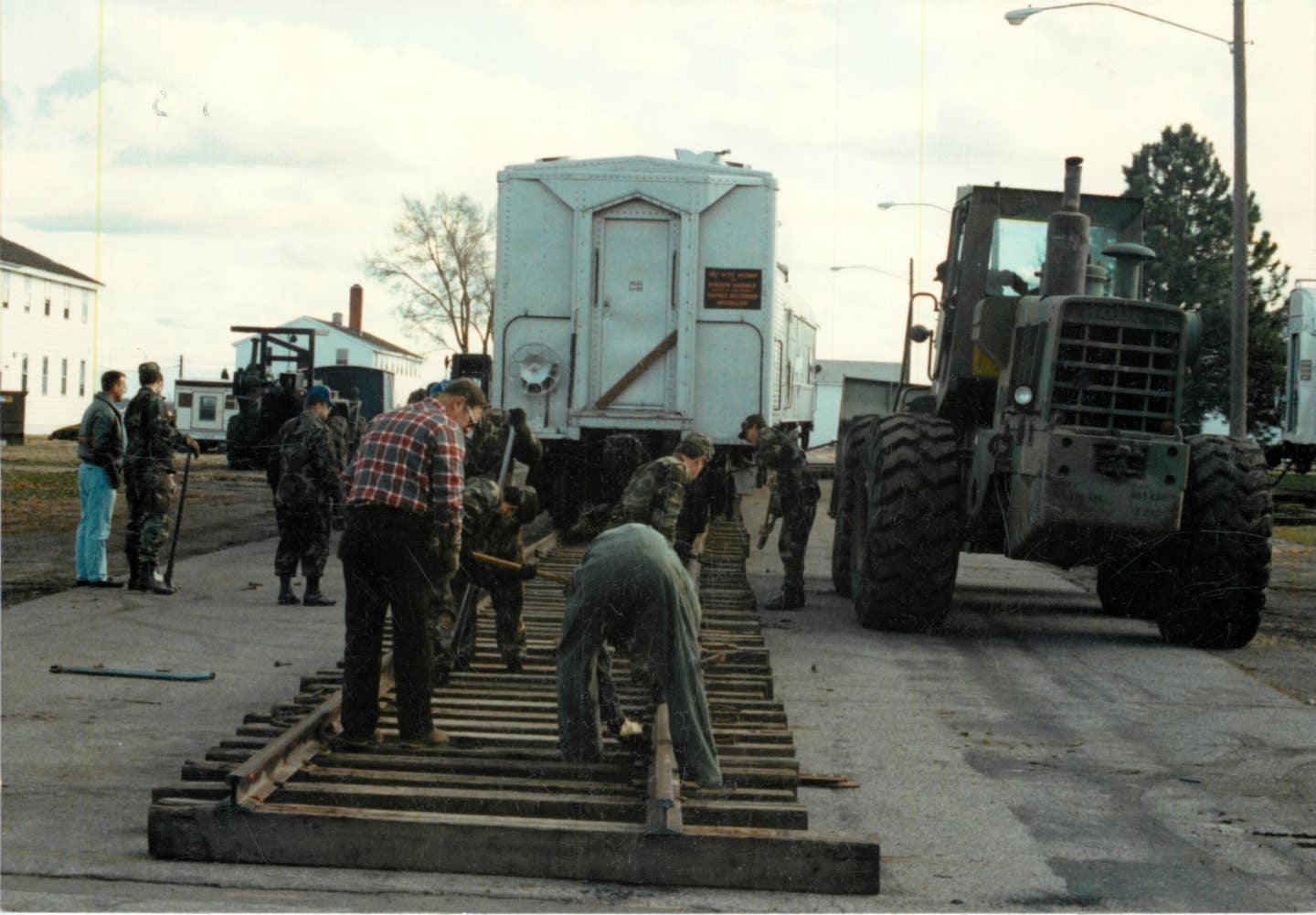 Volunteer workers lay tracks as part of Operation Cannonball, November 8, 1990, at Fairchild Air Force Base, Washington. <em>U.S. Air Force photo</em>