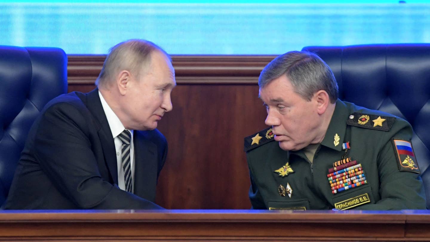 Russian President Vladimir Putin listens to Chief of the General Staff of the Russian Armed Forces Valery Gerasimov during the annual meeting of the Defence Ministry board in Moscow on December 21, 2021.
