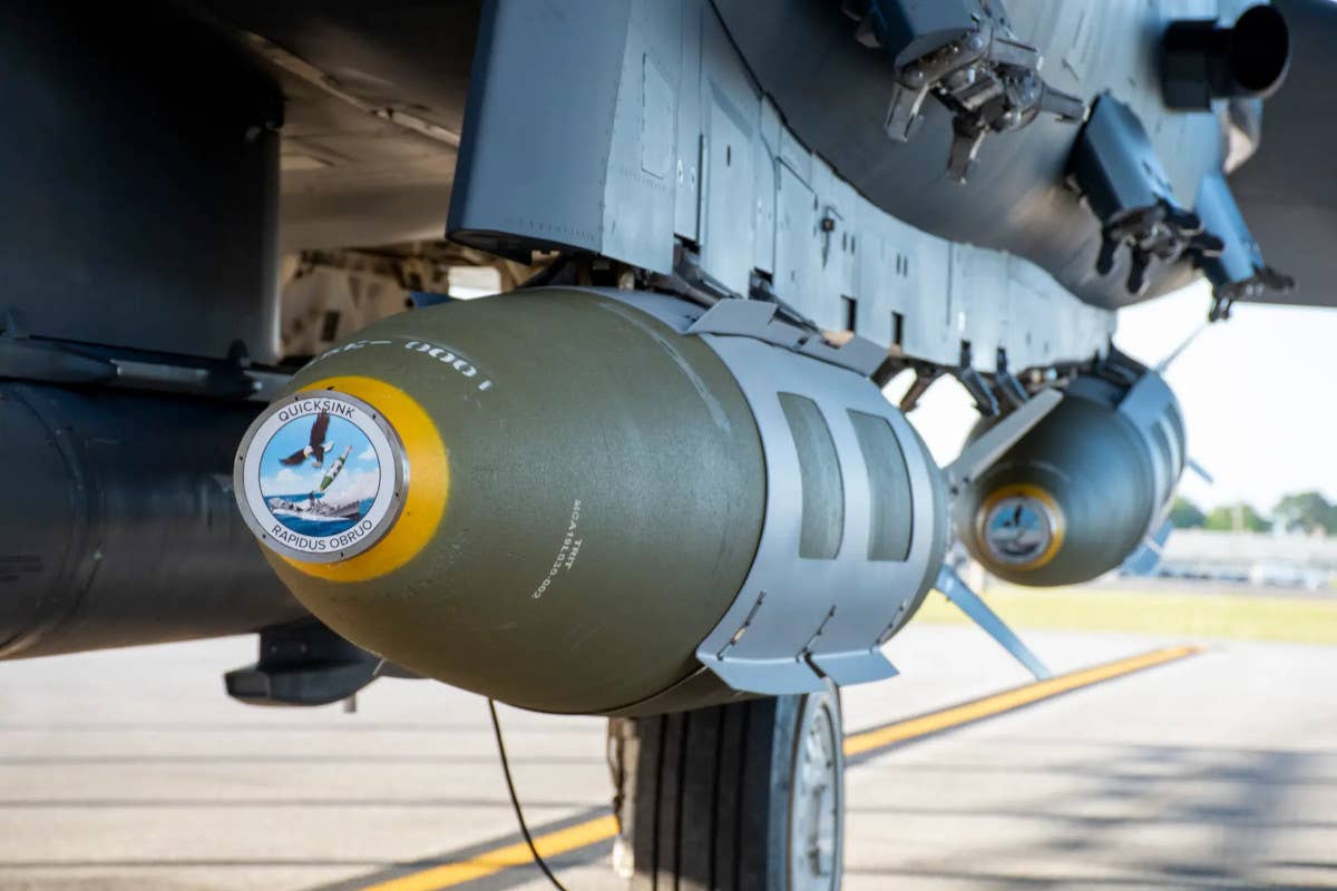 A picture that the Air Force released after the Quicksink test on April 28, 2022, showing live GBU-31/B Joint Direct Attack Munition bombs without anything fitted to their noses loaded on an F-15E Strike Eagle combat jet. The modified GBU-31/B being developed as part of Quicksink includes a new nose-mounted seeker, which has never been seen publicly to date.