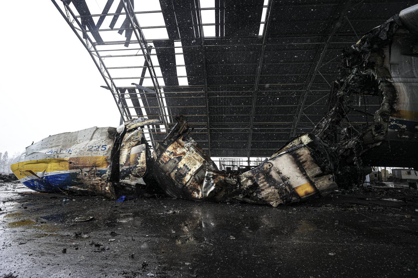 A view of the wreckage of the An-225 Mriya cargo plane, the world's biggest aircraft, destroyed by Russian shelling as Russia's attack on Ukraine continues, in a shelter at Hostomel, Ukraine on April 3, 2022. <em>Photo by Metin Aktas/Anadolu Agency via Getty Images</em>