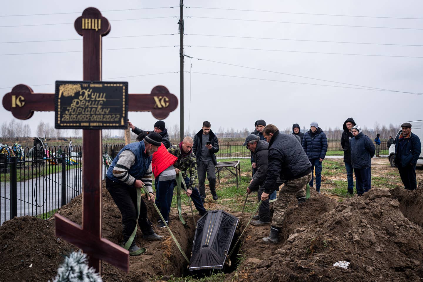 Cemetery workers dig graves and bury civilians who were killed during the Russian attacks in Bucha, Ukraine on April 22, 2022. <em>Photo by Wolfgang Schwan/Anadolu Agency via Getty Images</em>