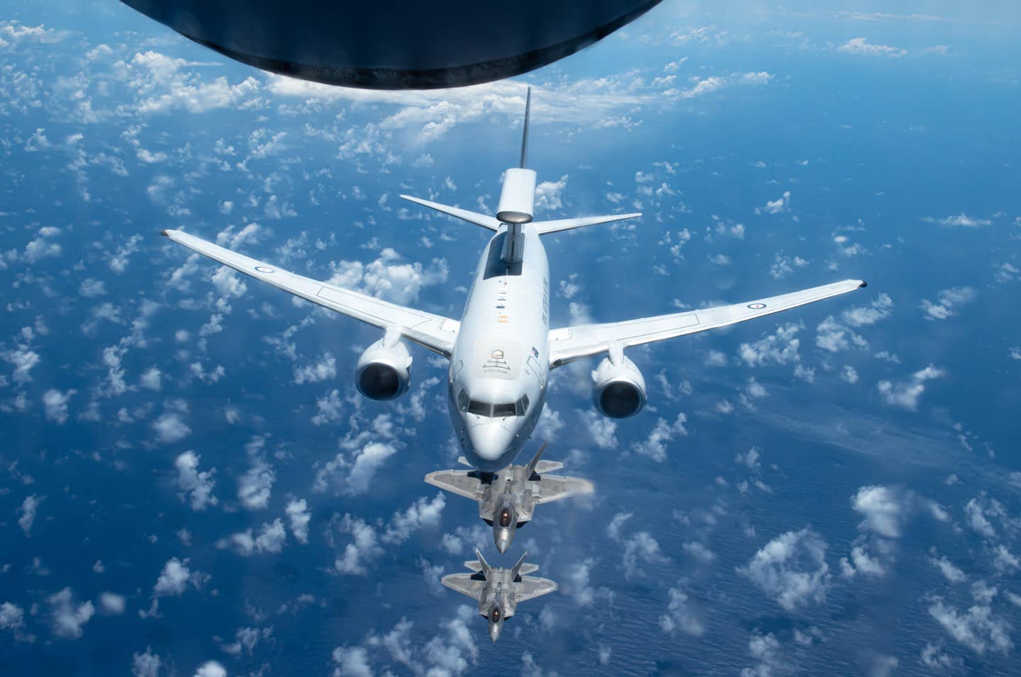 A Royal Australian Air Force E-7A Wedgetail in formation with Hawaii Air National Guard F-22 Raptors, near Oahu, Hawaii. <em>U.S. Air National Guard photo by Staff Sgt. John Linzmeier</em>