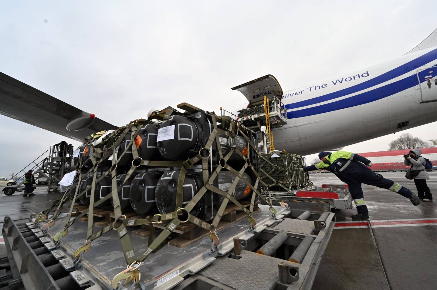Employees unload a Boeing 747-400 cargo jet with FGM-148 Javelin missiles as part of military support to Ukraine. (Photo by Sergei SUPINSKY / AFP) (Photo by SERGEI SUPINSKY/AFP via Getty Images)