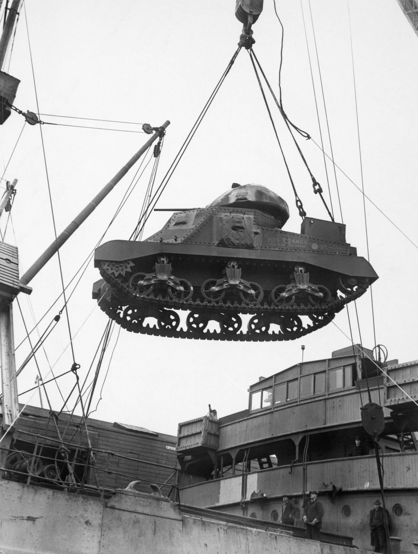 A lend-lease tank coming over the side of a cargo ship in a U.S. Atlantic Coast port. World War II-era photograph via Getty Images.