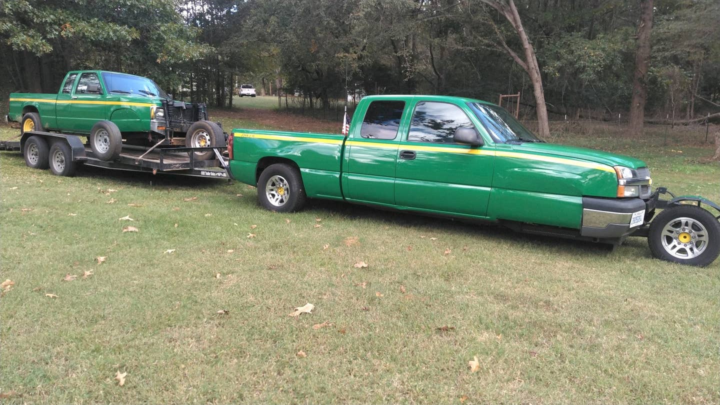 A green three-wheeled Chevrolet Silverado pickup truck hauls a trailer with a green three-wheeled Chevrolet S10 pickup truck