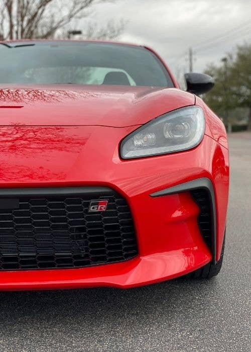 Front half of red Toyota GR86 sports car