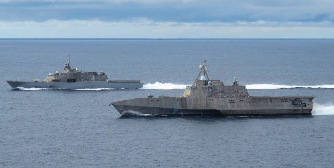 The USS <em>Freedom</em>, at left, sails alongside the USS <em>Independence</em>. <em>USN</em>