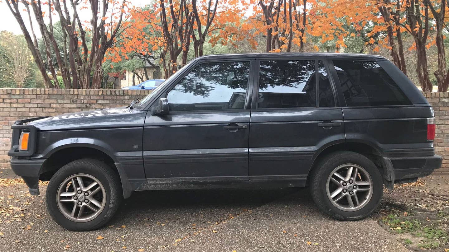Range Rover SUV in driveway with fall leaves