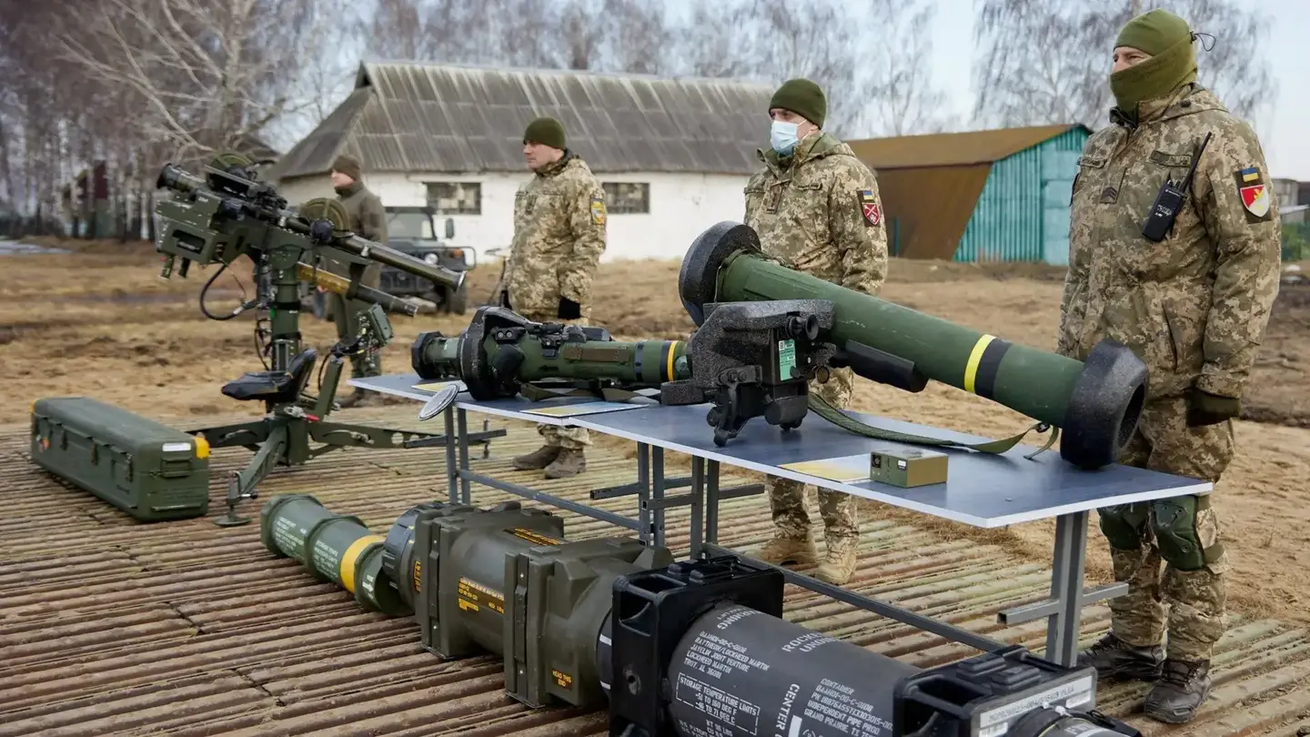 Members of the Ukrainian Armed Forces stand in front of various foreign-supplied missile launchers, including a pedestal-mounted twin Stinger launcher, at far left, and a Javelin anti-tank missile system, at right closest to the camera.&nbsp;<em>Ukrainian Armed Forces</em>