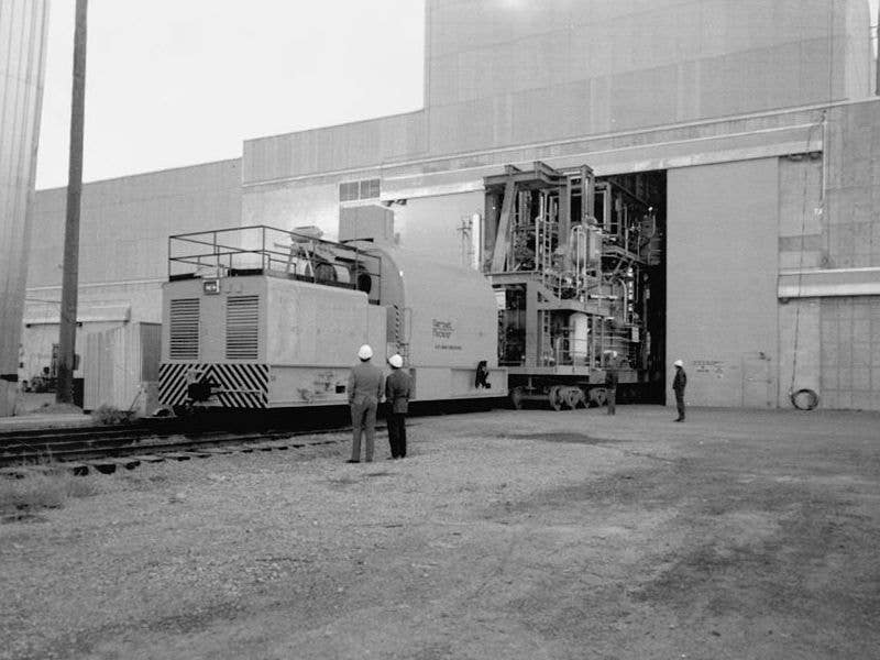 Idaho National Laboratory's radiation-shielded locomotive pushes a nuclear test rig into a building | Library of Congress