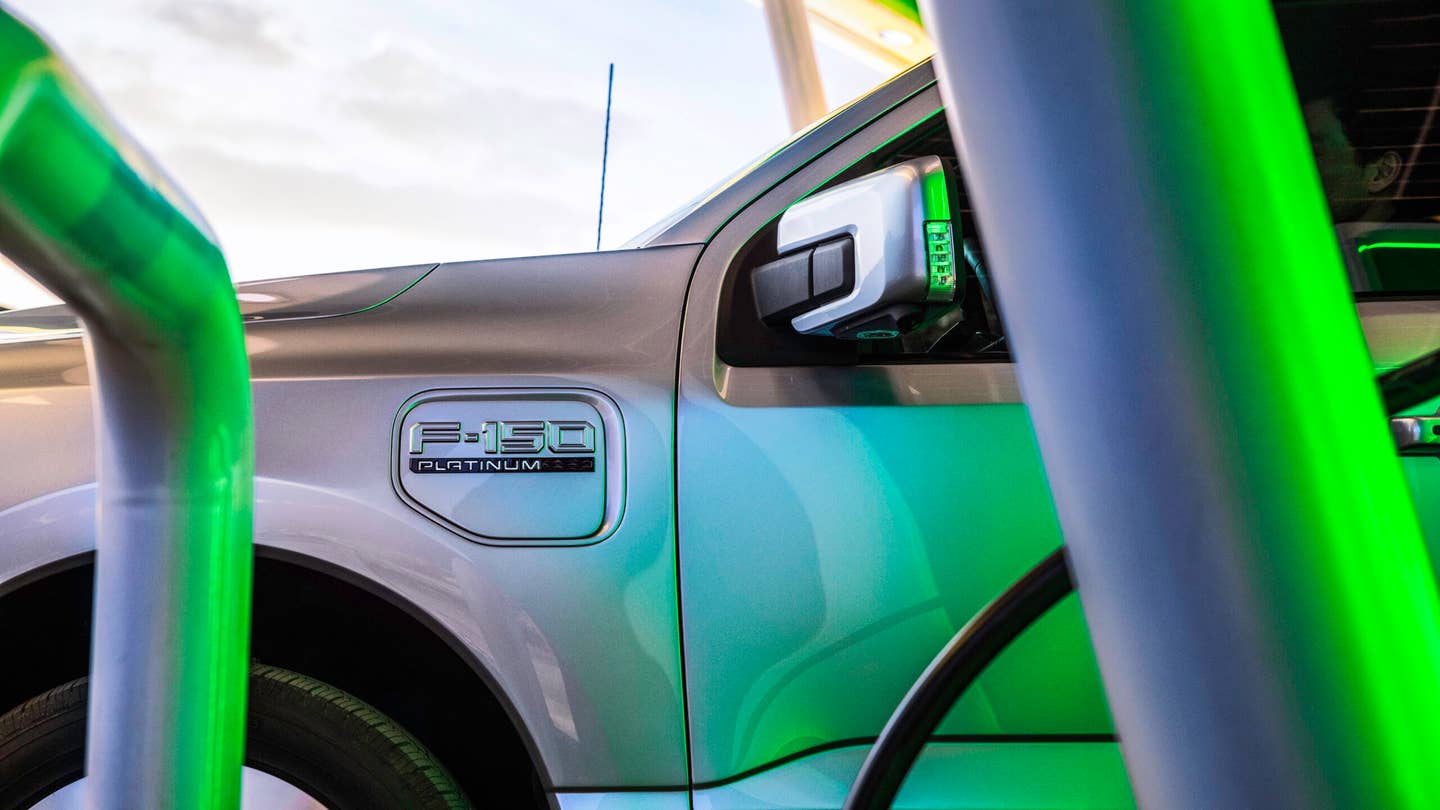 The Ford F-150 Lightning all-electric pickup truck charges at a public charger.