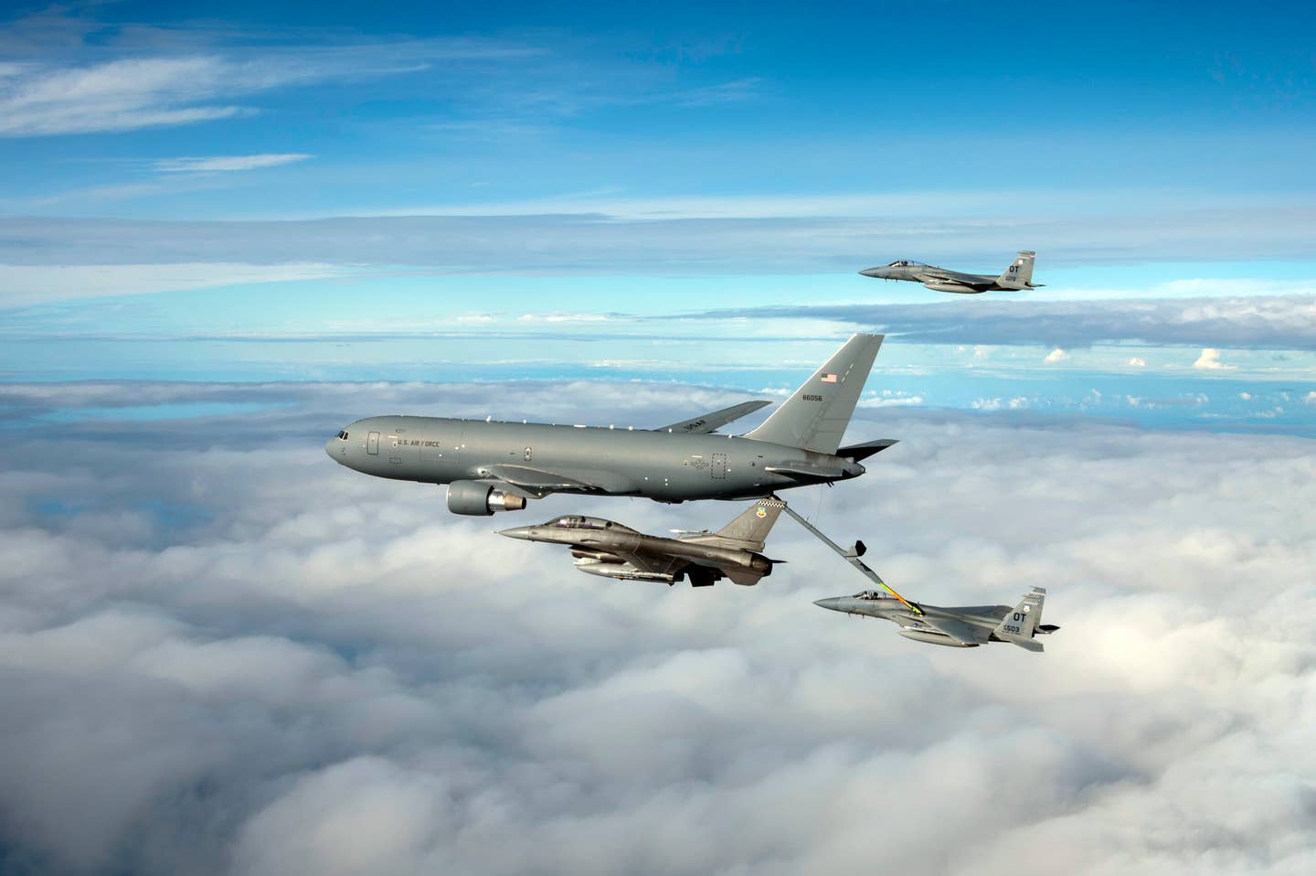 A KC-46 Pegasus assigned to the 931st Air Refueling Wing, McConnell Air Force Base, Kansas, refuels an F-15C Eagle while an F-16 Fighting Falcon and F-15C assigned to Eglin AFB, Florida, fly alongside over the Gulf of Mexico, Nov. 18, 2021. <em>U.S. Air Force photo by Staff Sgt. Betty R. Chevalier.</em>