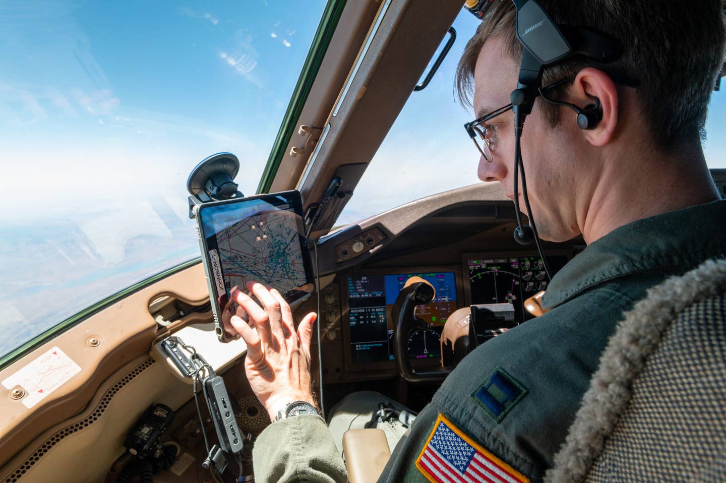 Captain Taylor Johnson, 349th Air Refueling Squadron instructor pilot, checks the flight path details May 5, 2022. Johnson is able to see live updates of weather, air traffic and flight plans using a Stratus puck. <em>U.S. Air Force photo by Airman Brenden Beezley.</em>
