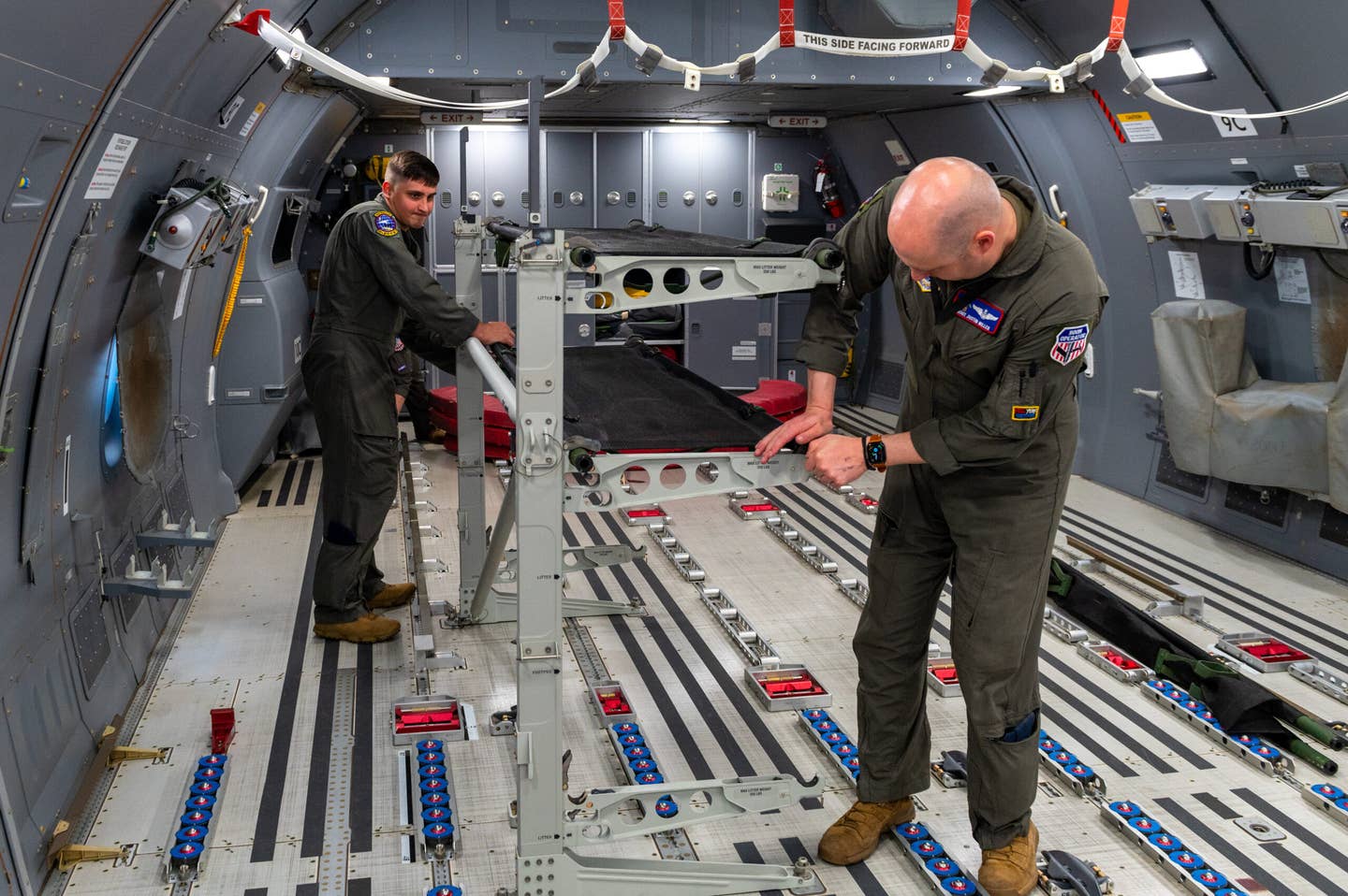 Staff Sgt. Jonathan Sanders and Master Sgt. Justin Miller, 349th Air Refueling Squadron boom operators, set up palletized cots in the back of a KC-46A Pegasus May 5, 2022. The crew were flying a 24-hour sortie, the longest in Air Mobility Command’s history. In order to ensure the safety of the flight, two pilot crews rotated on and off four-hour shifts allowing adequate time for rest. (U.S. Air Force photo by Airman Brenden Beezley)