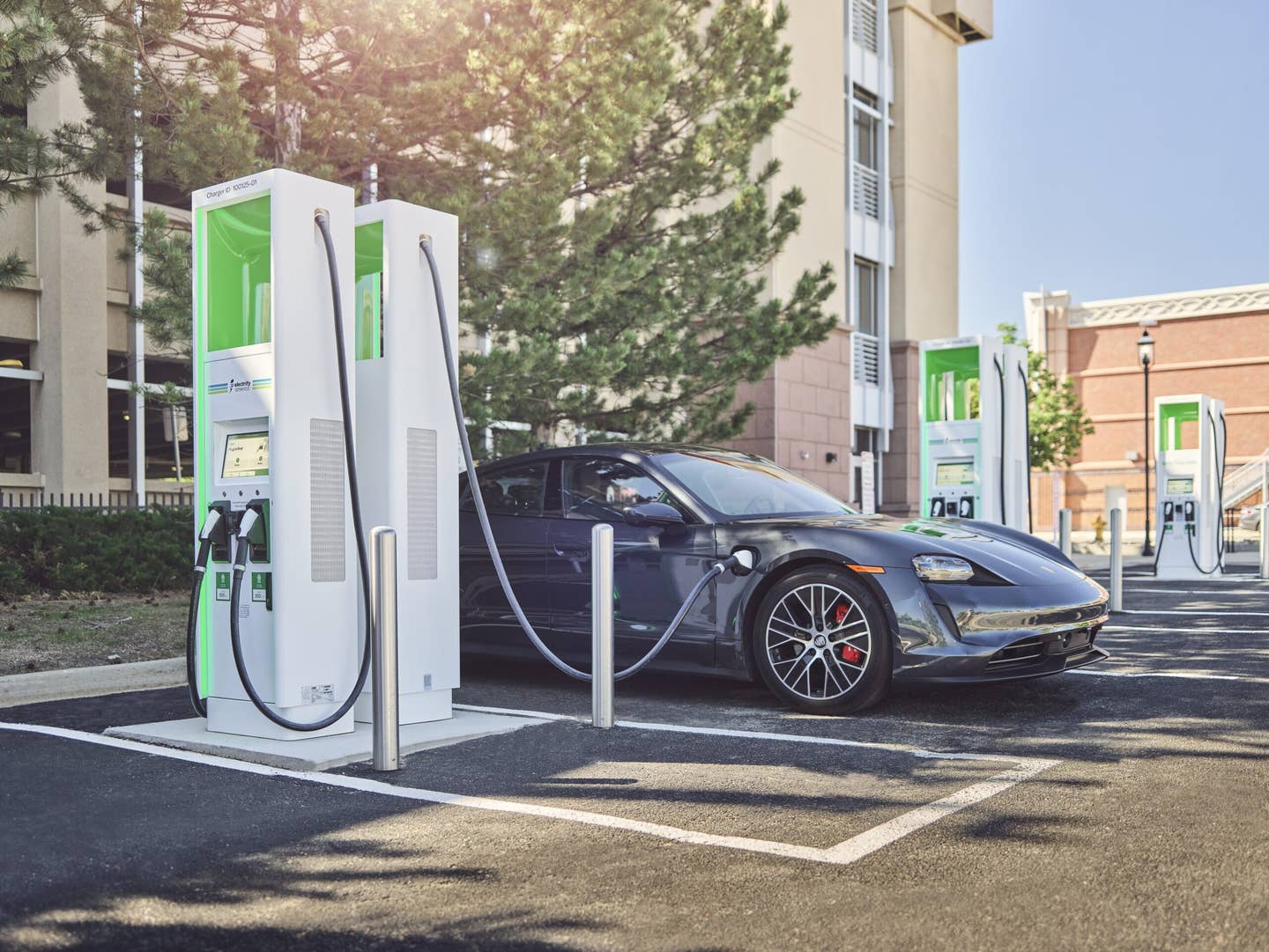 A Porsche Taycan electric car chargers an an Electrify America public charger.