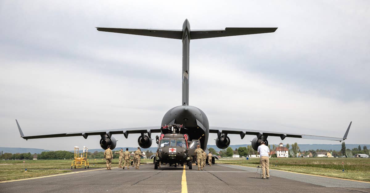 US Army soldiers load an HH-60 Black Hawk helicopter into a US Air Force C-17A airlifter at Clay Kaserne in Germany in April. The helicopter was subsequently airlifted to Norway as part of preparations for Swift Response.