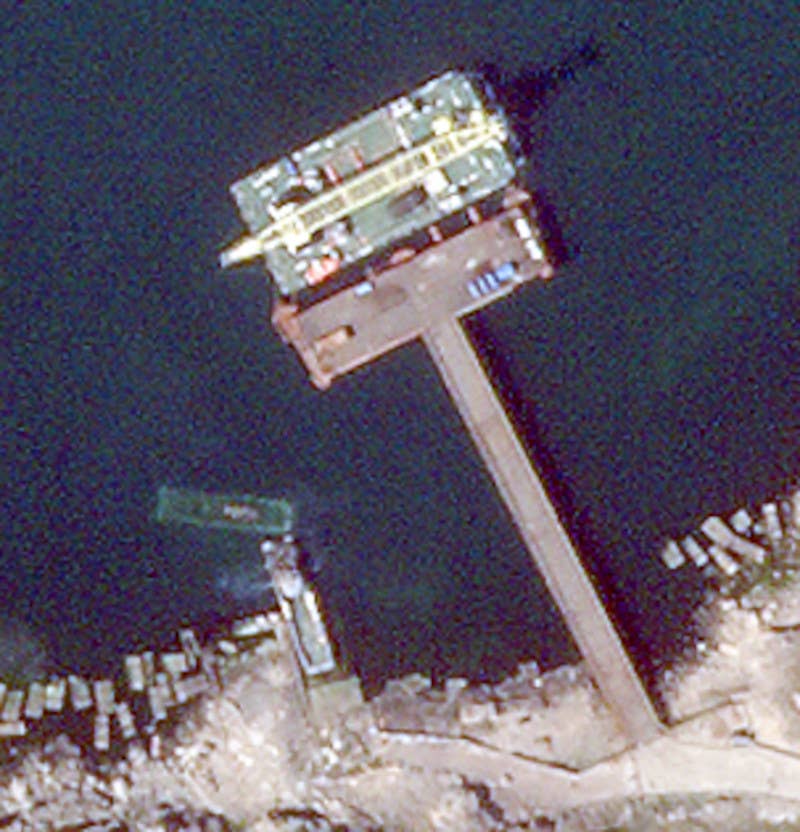 The May 12, 2022, image from Planet Labs clearly shows the sunken <em>Serna</em> class landing craft at the boat ramp near Snake Island's main dock, as well as another example of one of these landing craft that now appears to be docked there. <em>PHOTO © 2022 PLANET LABS INC. ALL RIGHTS RESERVED. REPRINTED BY PERMISSION</em>