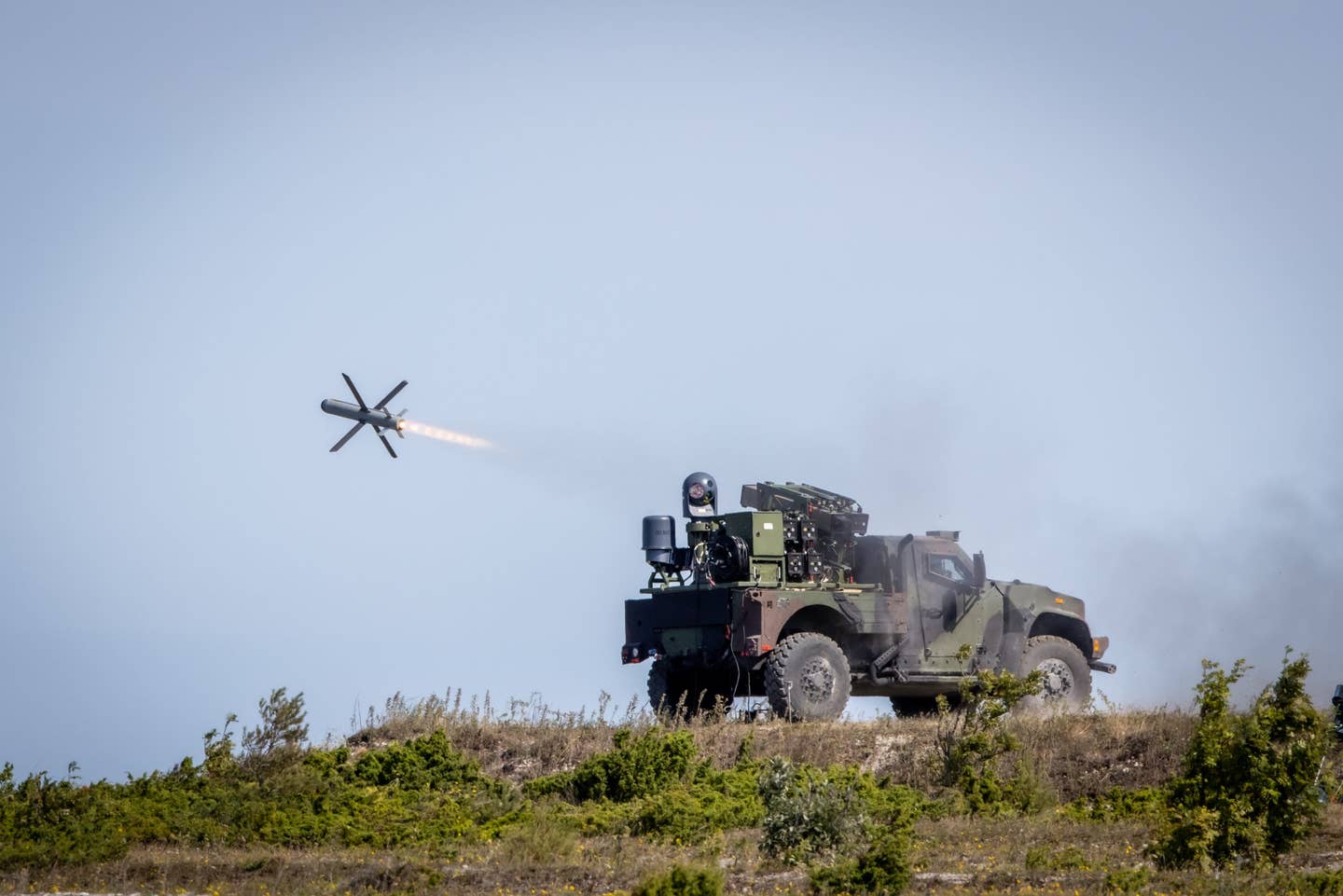 A two-door JLTV fires a Spike NLOS missile during an international demonstration. <em>Oshkosh Defense</em>