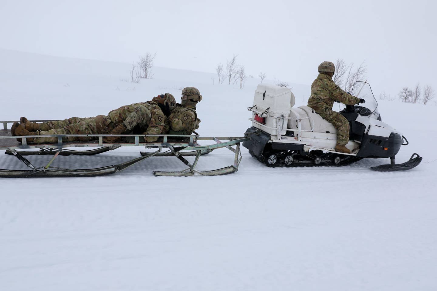Paratroopers from the 4th Brigade Combat Team, 25th Infantry Division (Airborne) with Norwegian and Spanish allies conduct casualty evaluation training during Exercise Swift Response in May. <em>U.S. Army photo by Spc. Kendall Lewis, 40th Public Affairs Detachment</em>