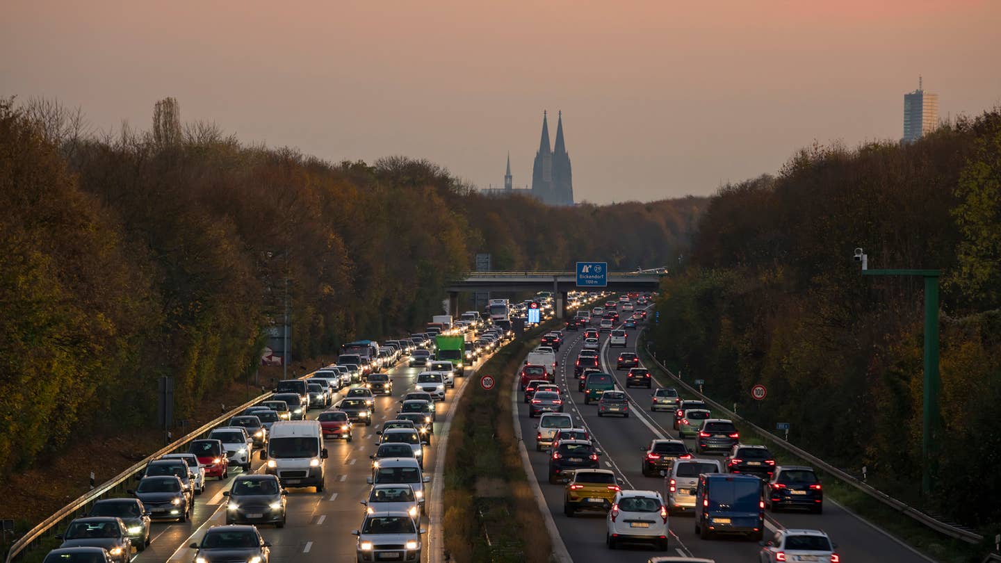Autobahn A57 during rush hour, Cologne Cathedral is visible in the distance (dusk) - Cologne, North Rhine-Westphalia