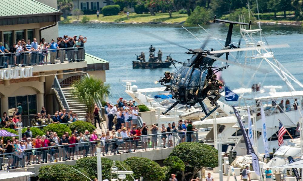 U.S. Special Operations Forces members fly over Tampa Bay in a U.S. Army MH-6 helicopter during a SOF capabilities demonstration. <em>U.S. Air Force</em>