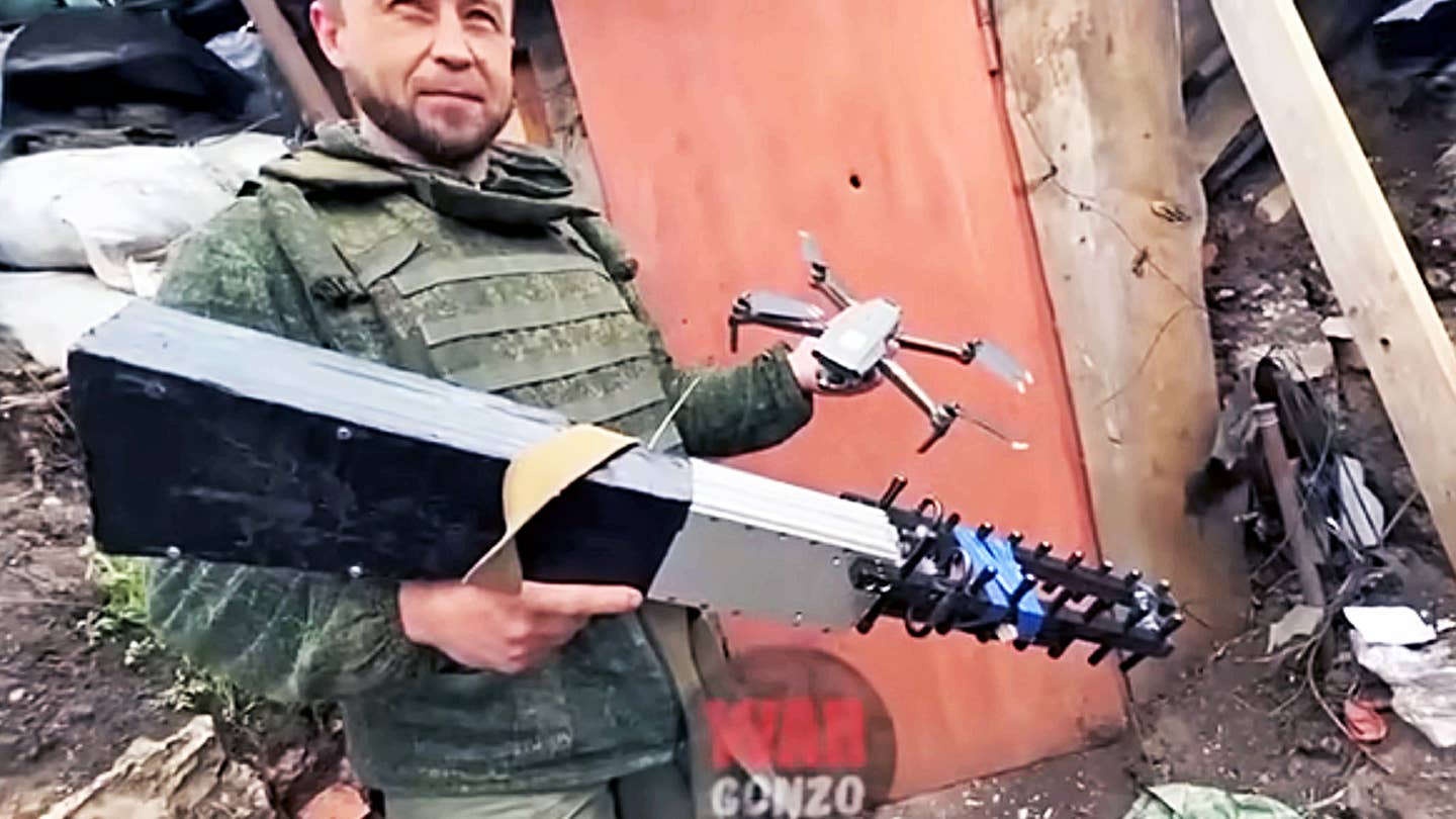 A Russian-backed separatist holds what is claimed to be an improvised counter-drone system.
