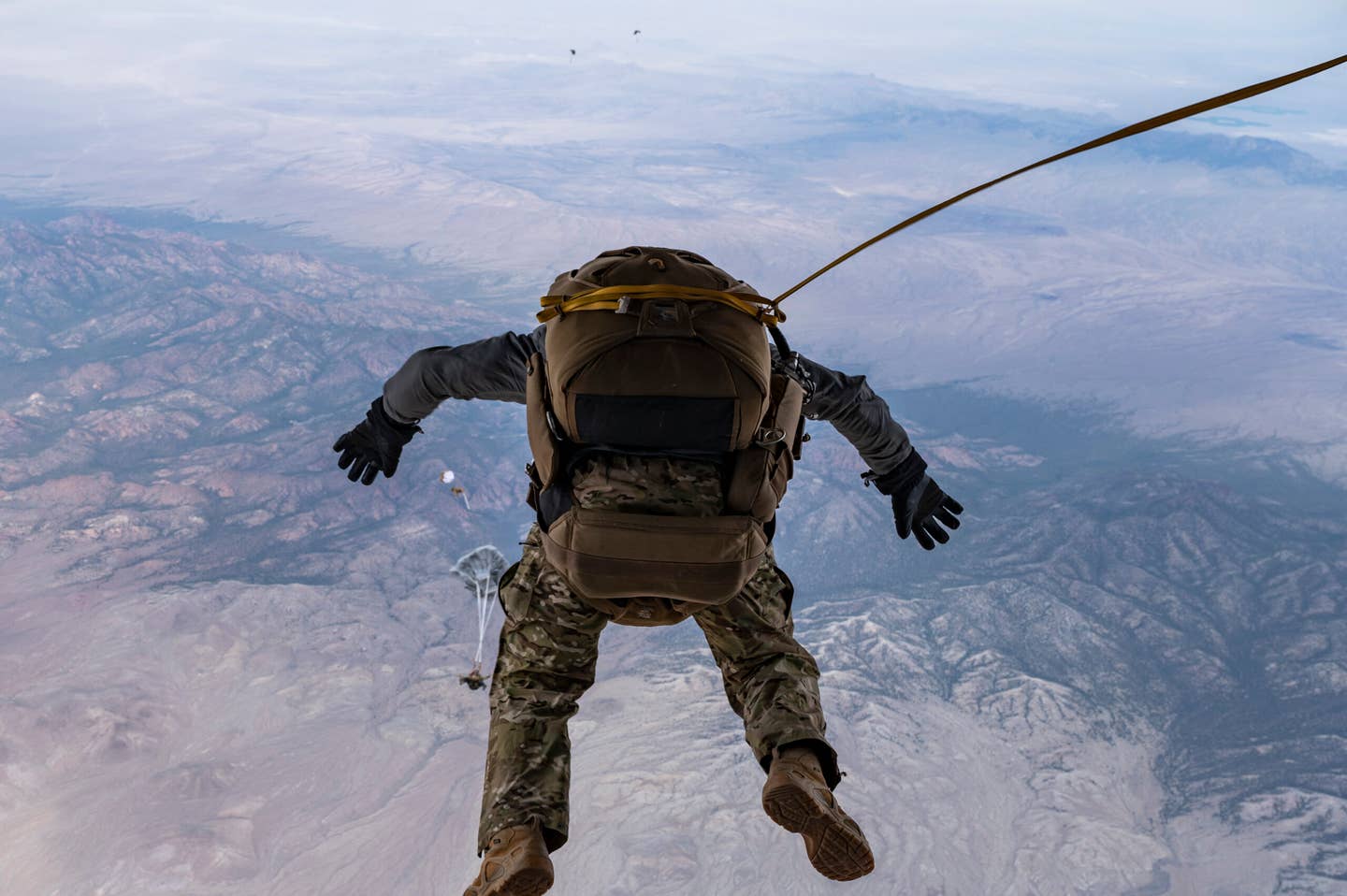 Tech. Sgt. Michael Valeich, 413th Flight Test Squadron Detachment 1 operator, exits the back of a HC-130J Combat King II to conduct a High-Altitude High-Opening (HAHO) jump during a Black Flag 22-1 training mission over the Nevada Test and Training Range, Nevada. <em>U.S. Air Force photo by Tech. Sgt. Alexandre Montes</em>