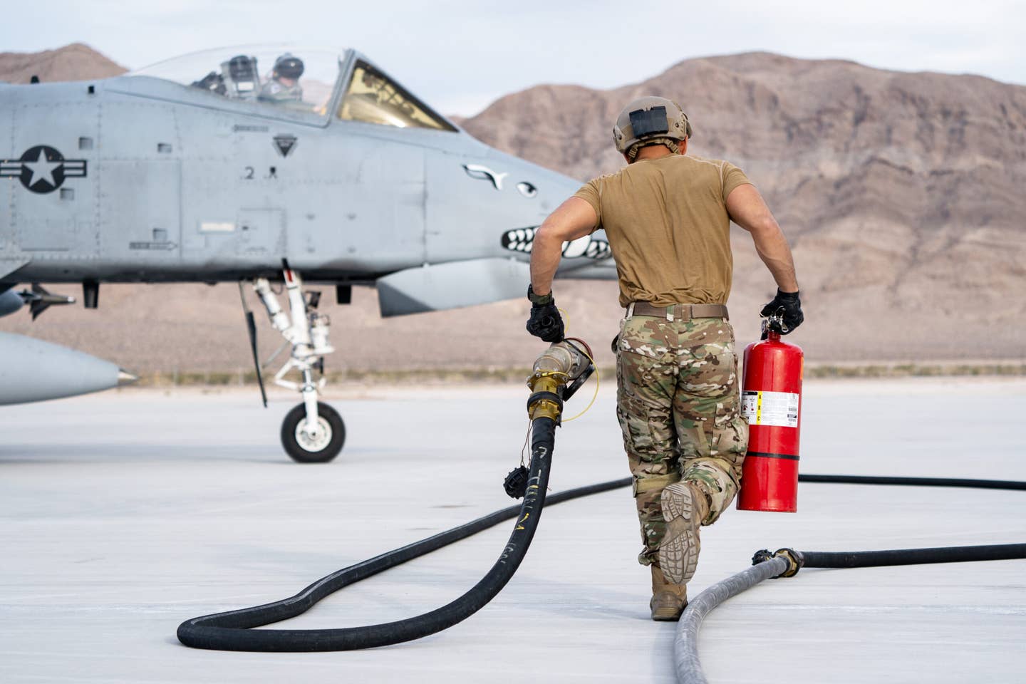 A Forward Area Refueling Point (FARP) operator runs to refuel an A-10C Thunderbolt II during Black Flag 22-1 at Nellis Air Force Base, Nevada, May 12, 2022. <em>U.S. Air Force photo by Airman 1st Class Josey Blades</em>