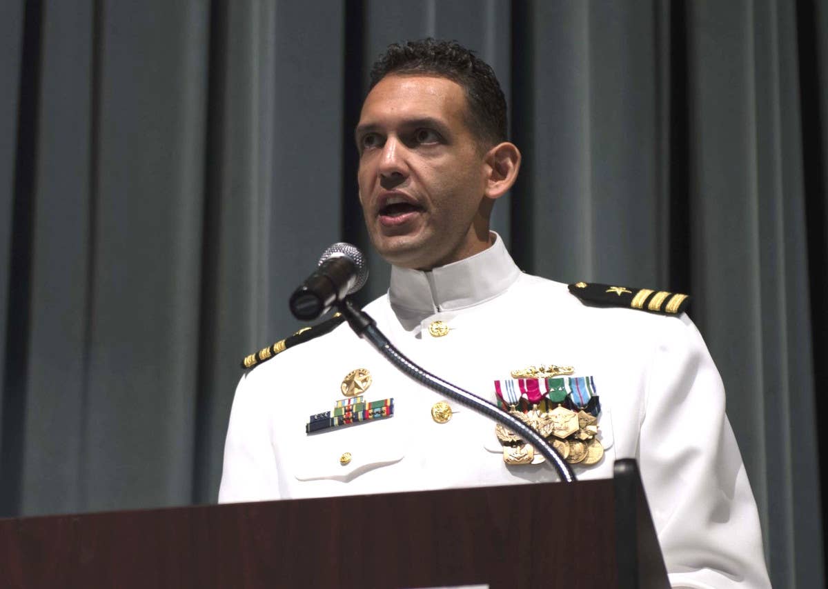 Cmdr. Cameron Aljilani speaks at a ceremony marking his assumption of command of the USS Connecticut in 2019. <em>USN</em>