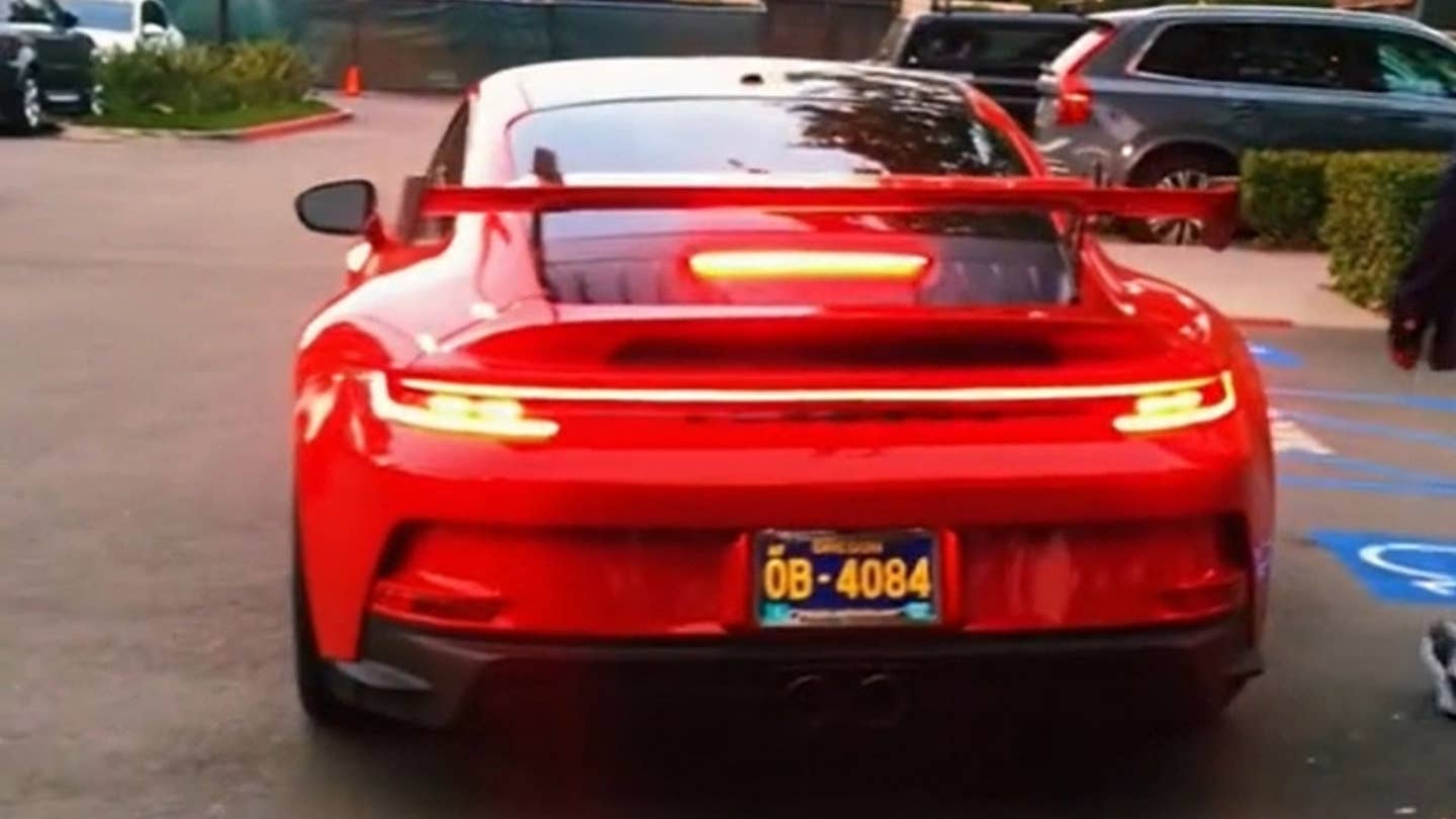 Rear view of red Porsche wih wing