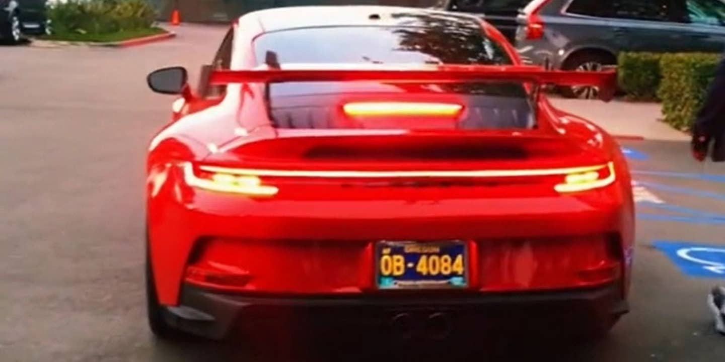 Rear view of red Porsche wih wing