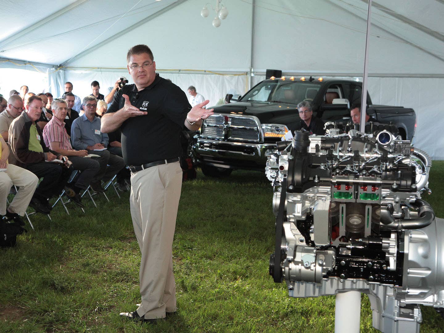 Ram official gestures to the 3.0-liter Ecodiesel V6 at an event in 2013 | Ram
