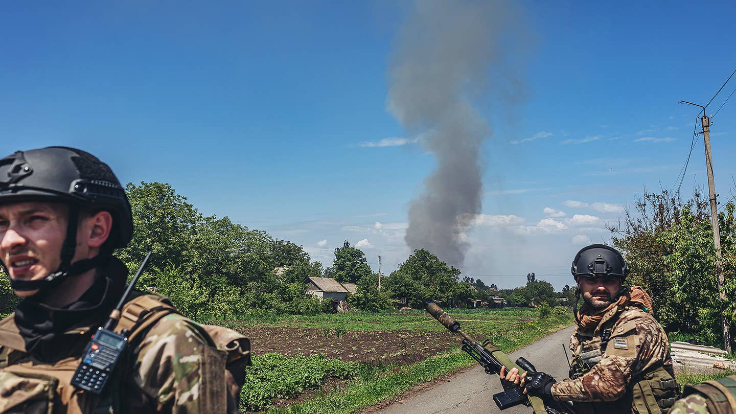DONBASS, UKRAINE - MAY 25: Two soldiers walk in front of a Russian missile fire in Donbass, Ukraine, 25 May 2022. (Photo by Diego Herrera Carcedo/Anadolu Agency via Getty Images)