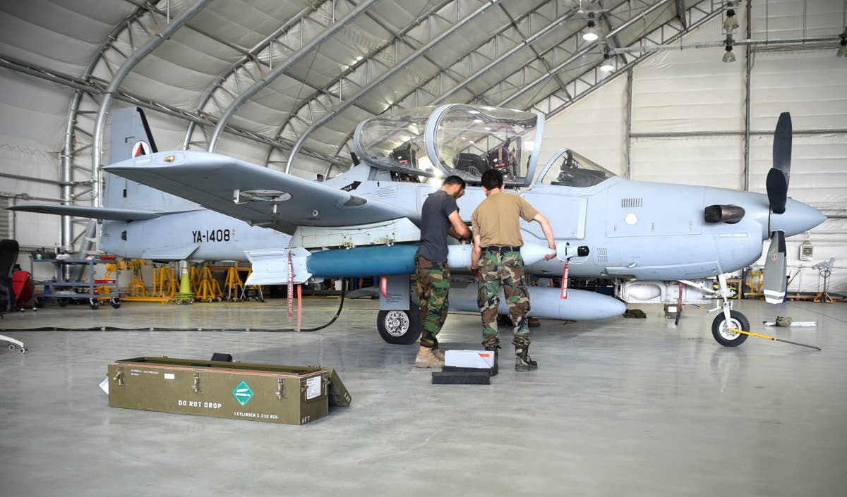 Afghan Air Force personnel practice assembling and loading laser-guided bombs onto the A-29 with an inert weapon. They have not employed this capability in combat. (Photo USAF)