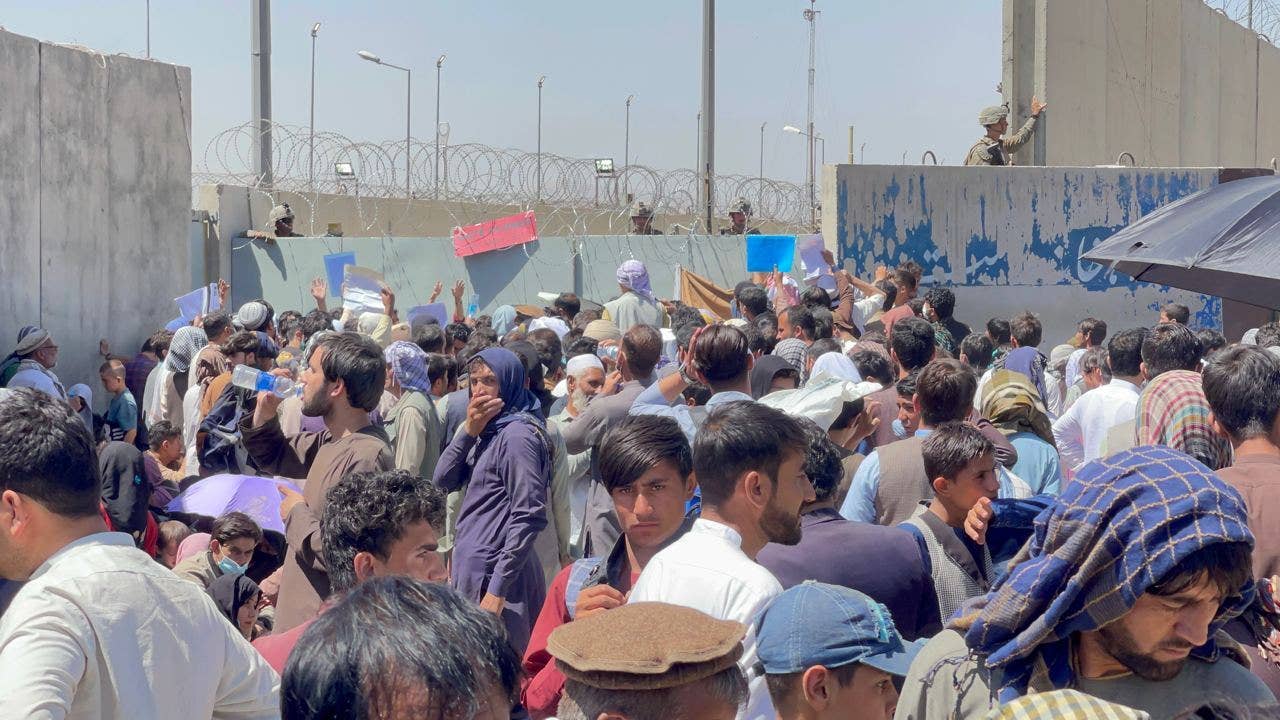 Afghan people wanting to leave the country waiting around Hamid Karzai International Airport in Kabul, Afghanistan on Aug. 26, 2021. (Photo by Haroon Sabawoon/Anadolu Agency via Getty Images)