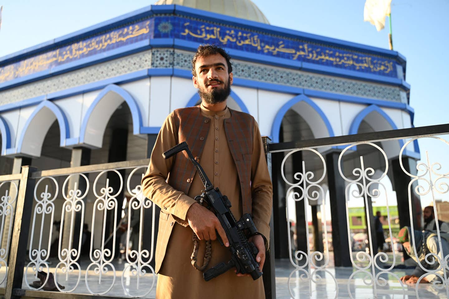 A Taliban fighter poses in front of a replica of Al-Aqsa Mosque at Kampani Square on the outskirts of Kabul on May 23, 2022. (Photo by WAKIL KOHSAR/AFP via Getty Images)