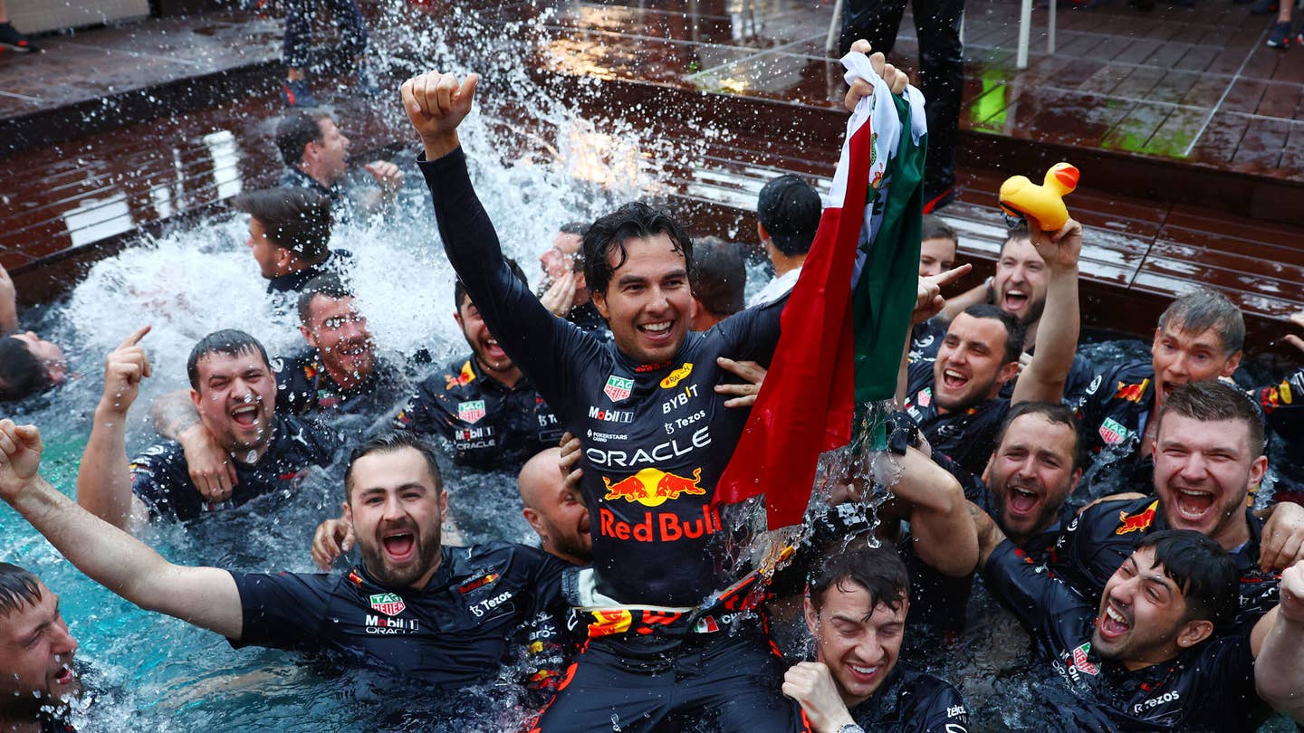 Sergio Perez celebrates in the pool of the Red Bull Energy Station after winning the 2022 Monaco Grand Prix