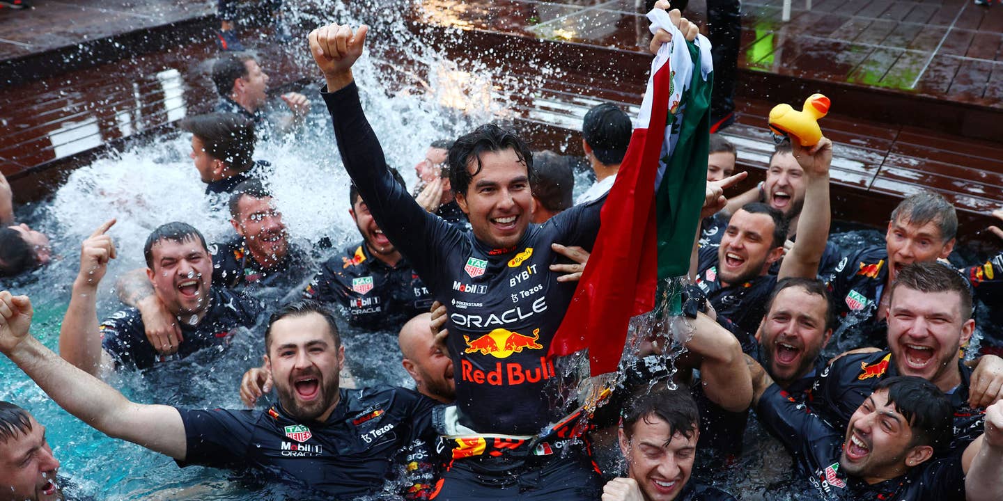 Sergio Perez celebrates in the pool of the Red Bull Energy Station after winning the 2022 Monaco Grand Prix