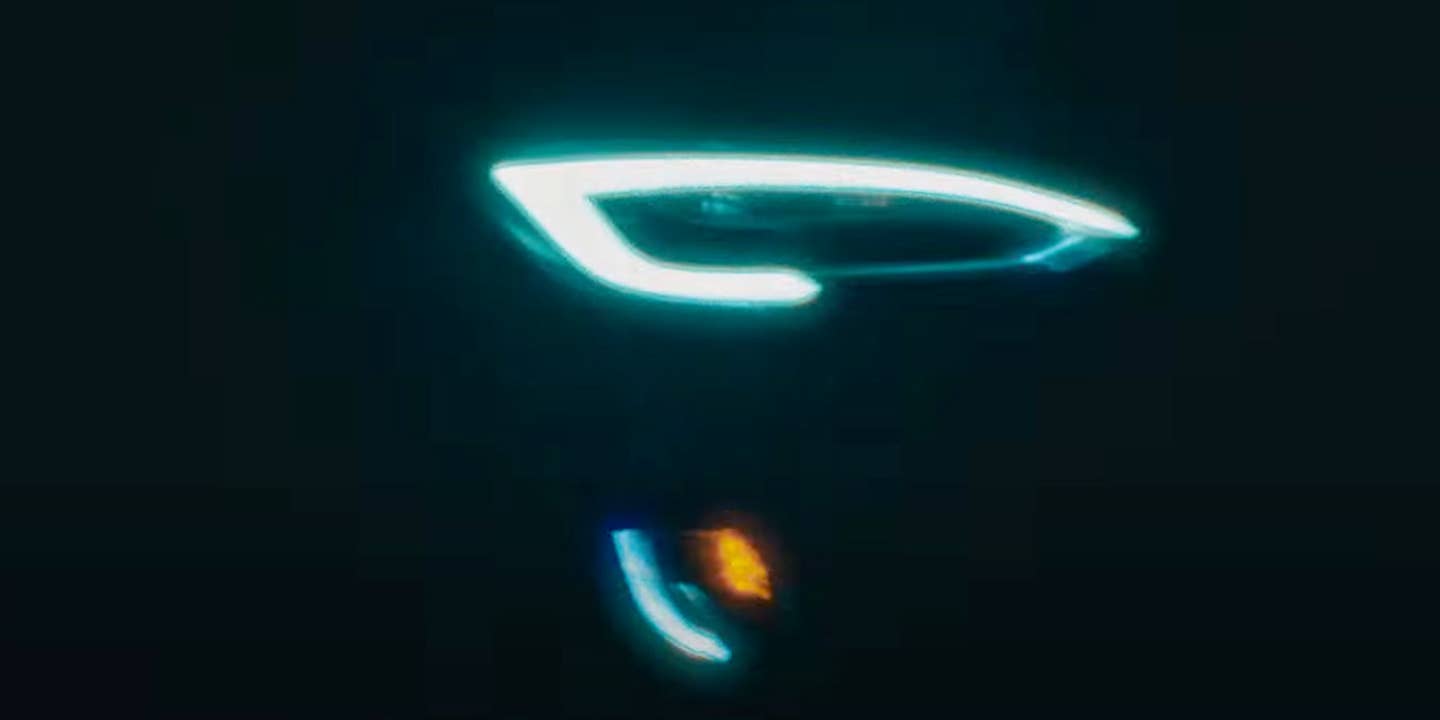 A Tesla headlight appears in a BMW M2 advertisement.