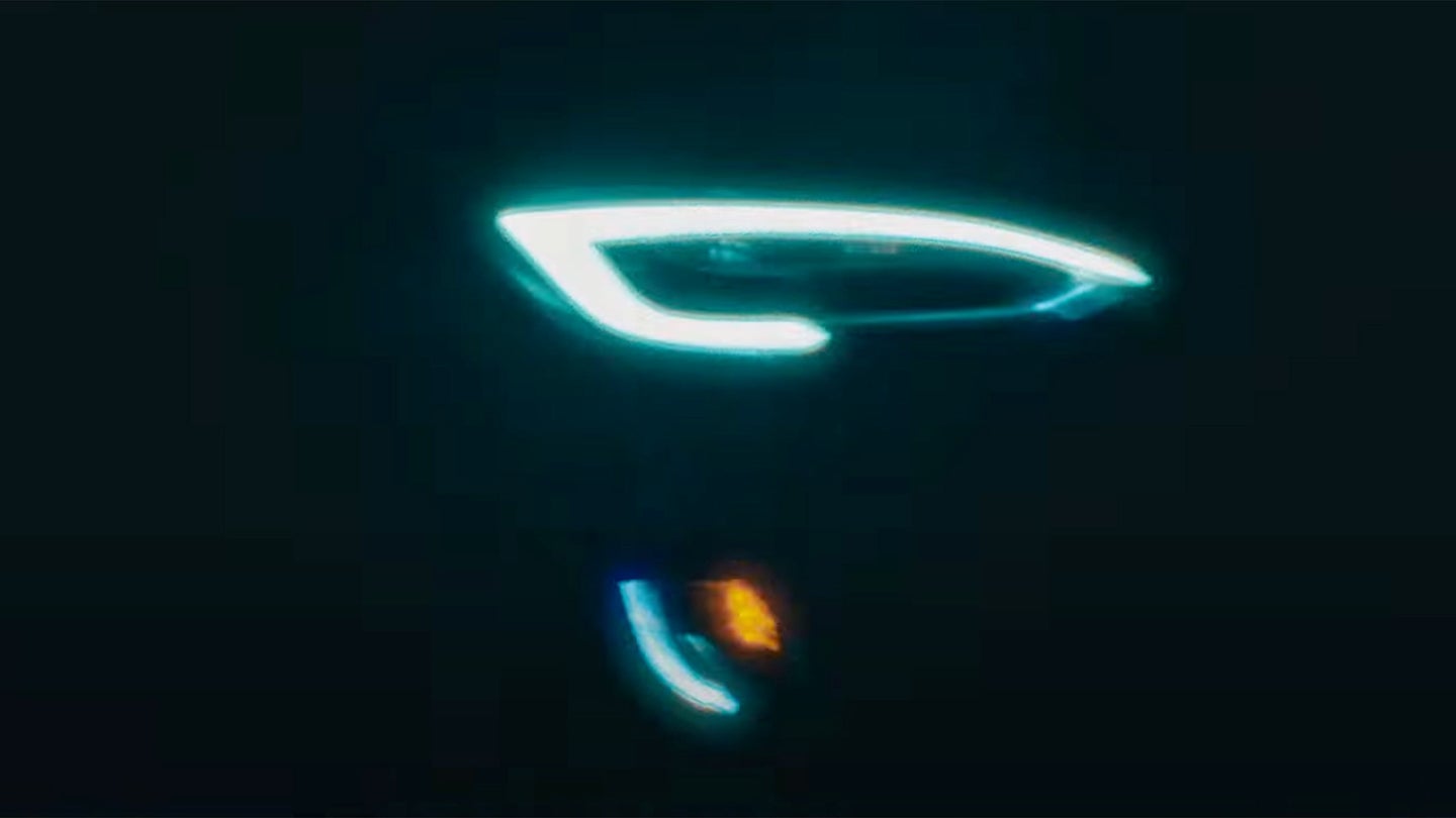 A Tesla headlight appears in a BMW M2 advertisement.
