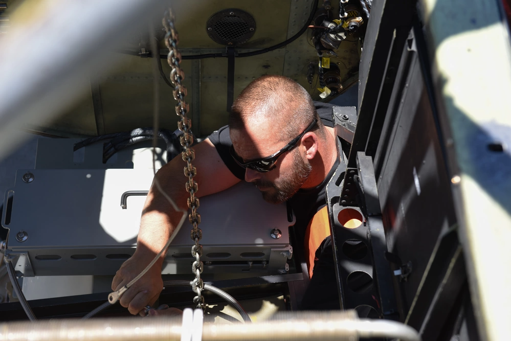 An OBC technician lowers the sensor out of the U-2 at Beale for the last time. <em>U.S. Air Force</em>