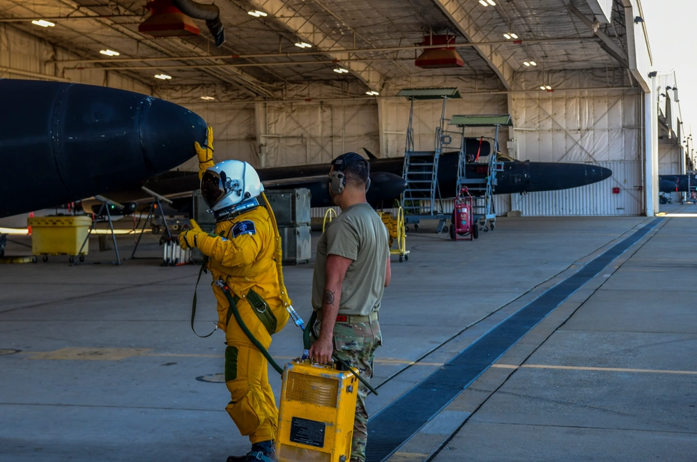 Lt. Col. Ralph Shoukry taps the U-2 dragon lady's nose for good luck before the Optical Bar Camera's final flight out of the 9th Reconnaissance Wing. <em>U.S. Air Force</em>