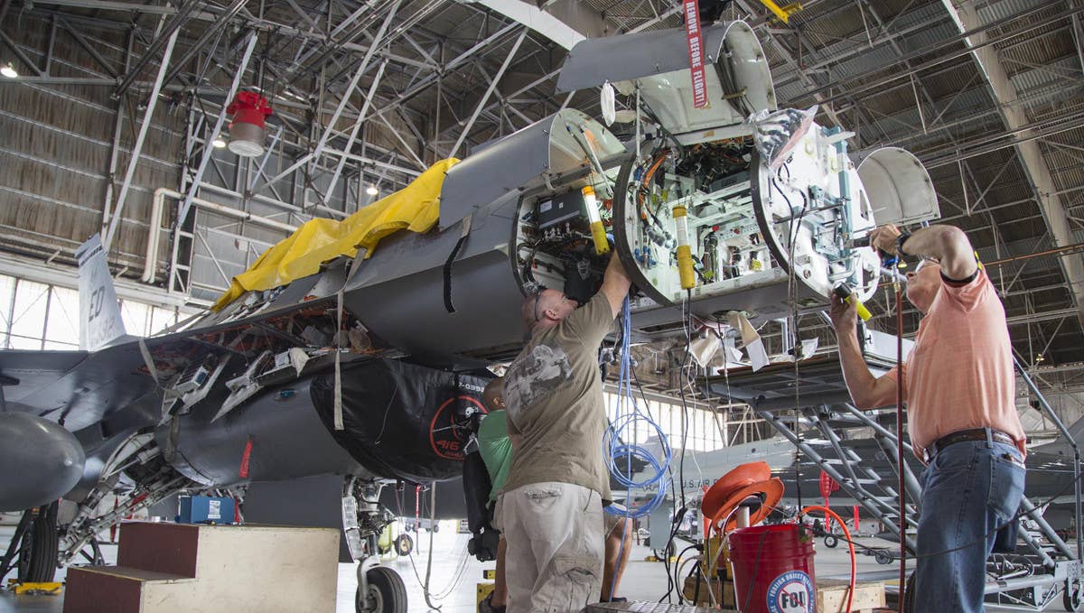 Technicians prepare an Air Force F-16 to receive a new AN/APG-83 radar. <em>Northrop Grumman</em>
